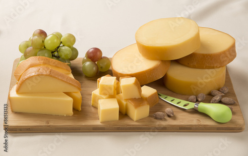 Different cheeses on a cutting board, delicious food
