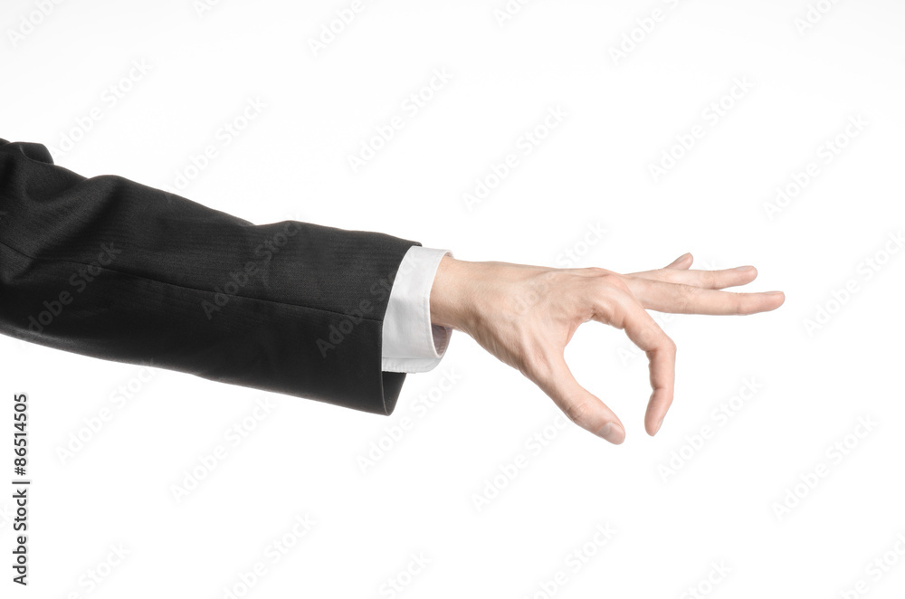Businessman and gesture topic: a man in a black suit and white shirt showing hand gesture on an isolated white background in studio Businessman and gesture topic: a man in a black suit and white shirt showing hand gesture on an isolated white background in studio