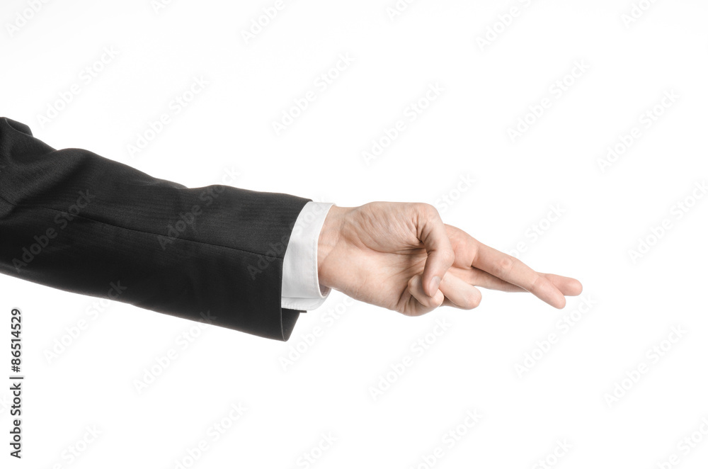 Businessman and gesture topic: a man in a black suit and white shirt showing hand gesture on an isolated white background in studio Businessman and gesture topic: a man in a black suit and white shirt showing hand gesture on an isolated white background in studio