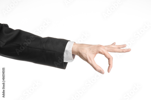 Businessman and gesture topic: a man in a black suit and white shirt showing hand gesture on an isolated white background in studio