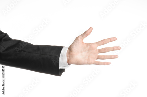 Businessman and gesture topic: a man in a black suit and white shirt showing hand gesture on an isolated white background in studio