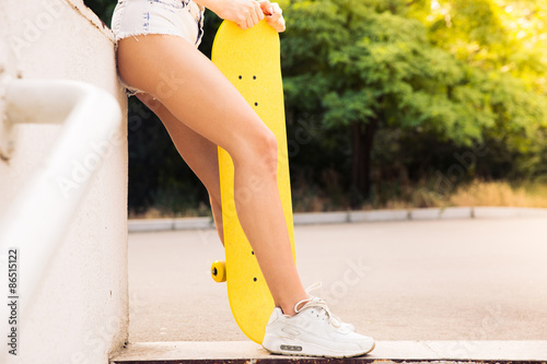 Female legs with skateboard