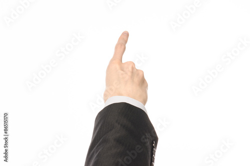 Gestures and Business theme: businessman shows hand gestures with a first-person in a black suit on a white background isolated