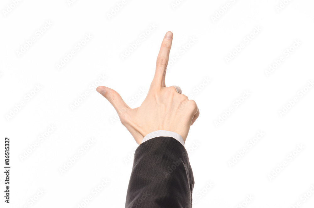 Gestures and Business theme: businessman shows hand gestures with a first-person in a black suit on a white background isolated Gestures and Business theme: businessman shows hand gestures with a first-person in a black suit on a white background isolated