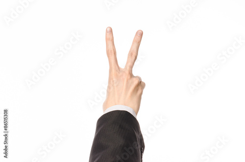 Gestures and Business theme: businessman shows hand gestures with a first-person in a black suit on a white background isolated