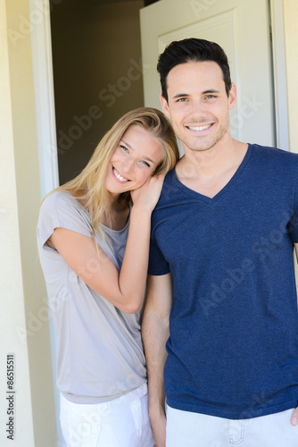 happy young couple man and woman opening door of their new home entrance © W PRODUCTION