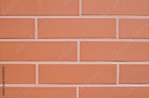 Red ceramic slabs imitating bricks on wall