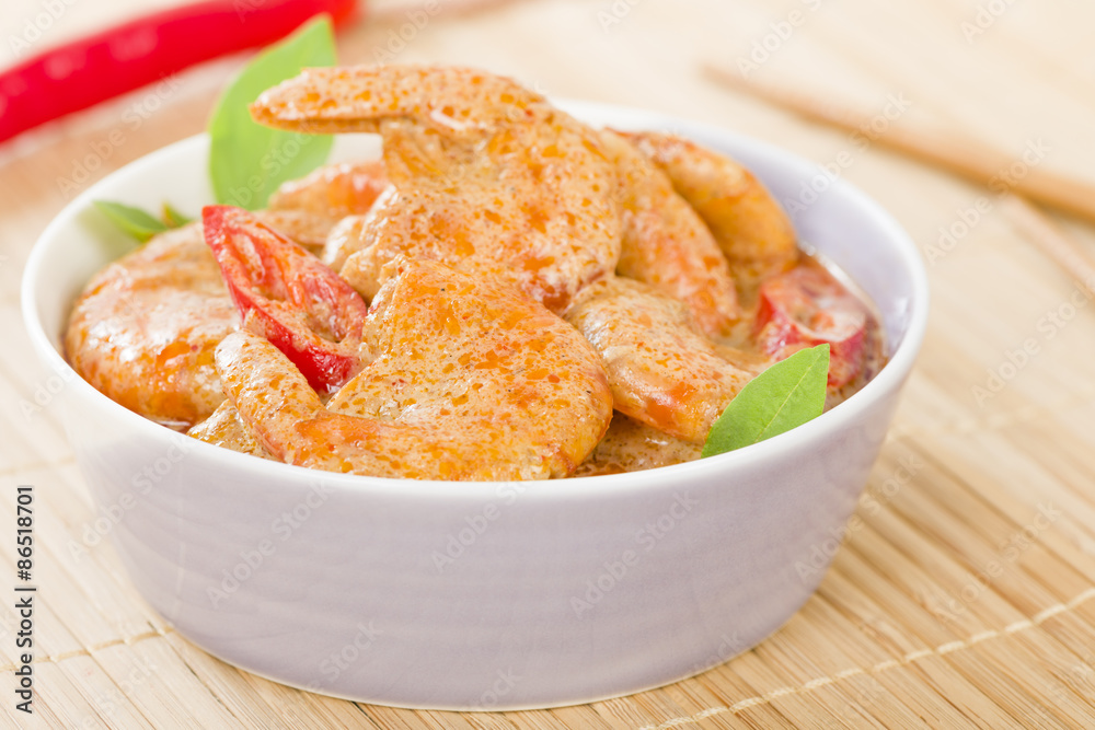 Thai Prawn Curry - King prawns in red curry sauce and coconut milk in a lilac bowl. Thai Prawn Curry - King prawns in red curry sauce and coconut milk in a lilac bowl.