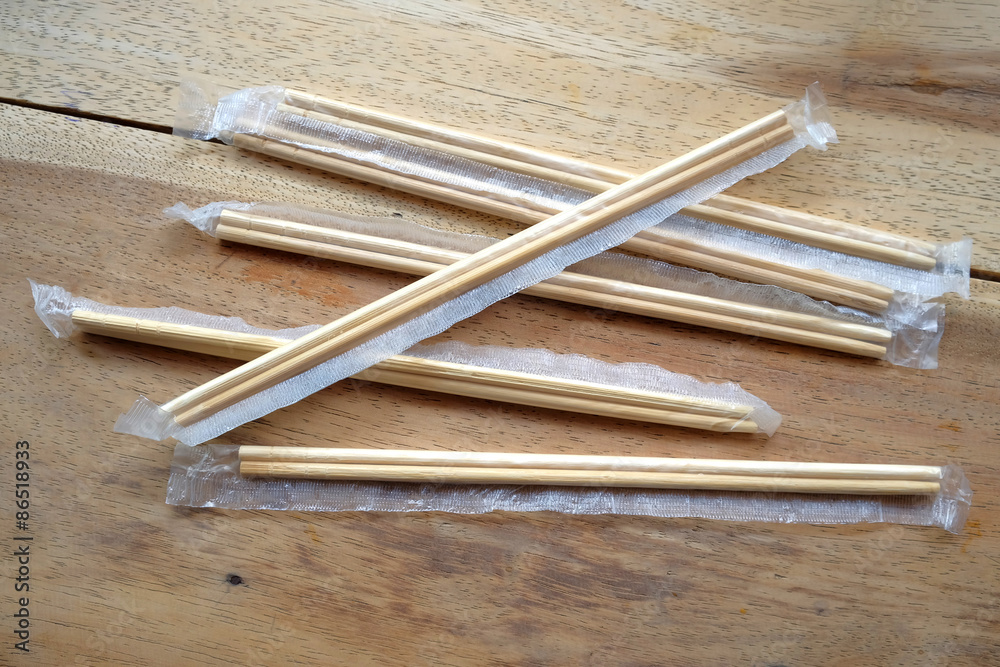 package of readymade bamboo chopsticks on wooden background package of readymade bamboo chopsticks on wooden background