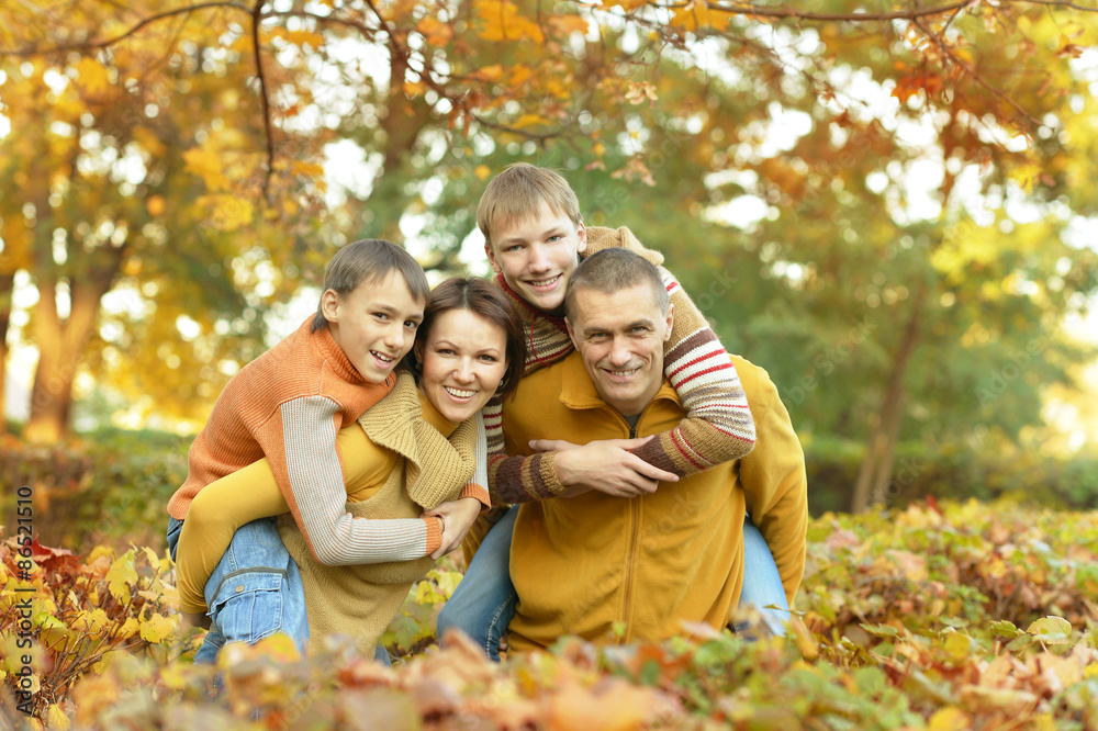 Family relaxing in autumn park