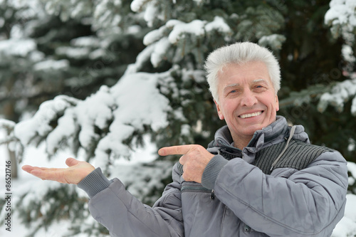 Elderly man in winter pointing
