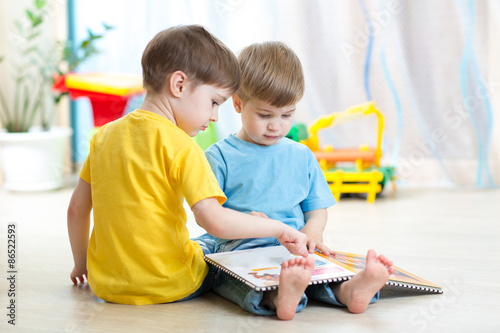 children read a book sittin...