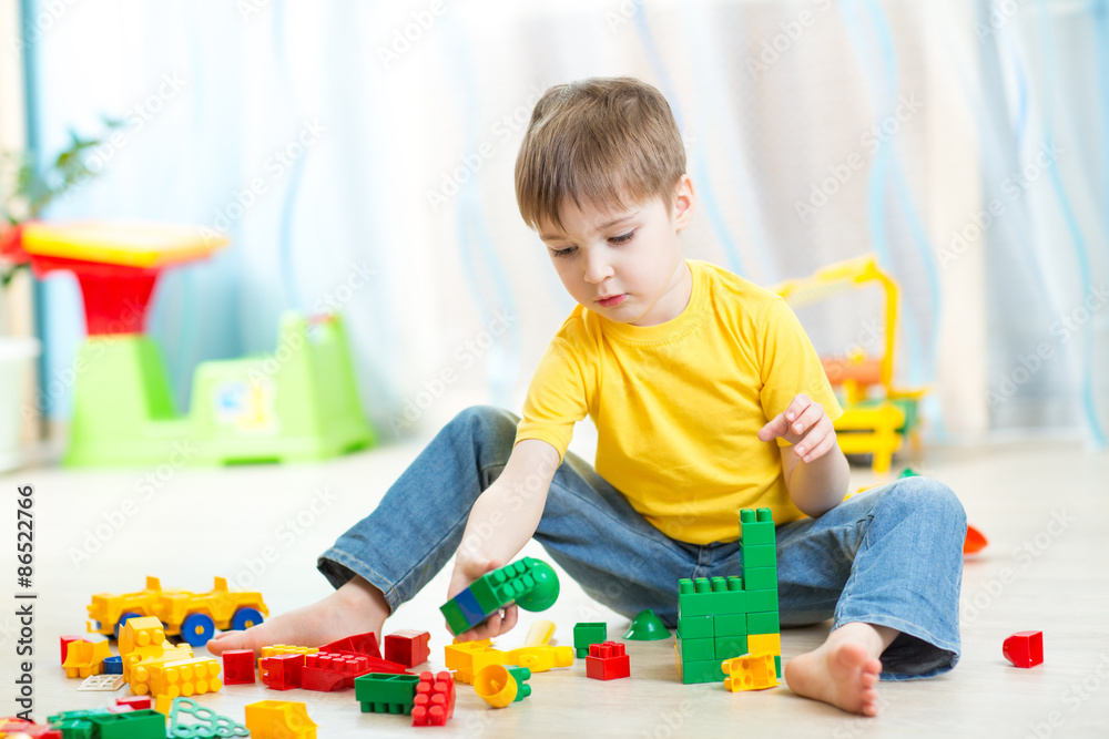 child boy plays on floor in nursery child boy plays on floor in nursery