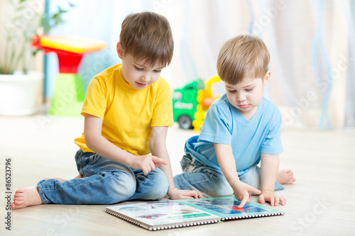 brothers kids read book tog...
