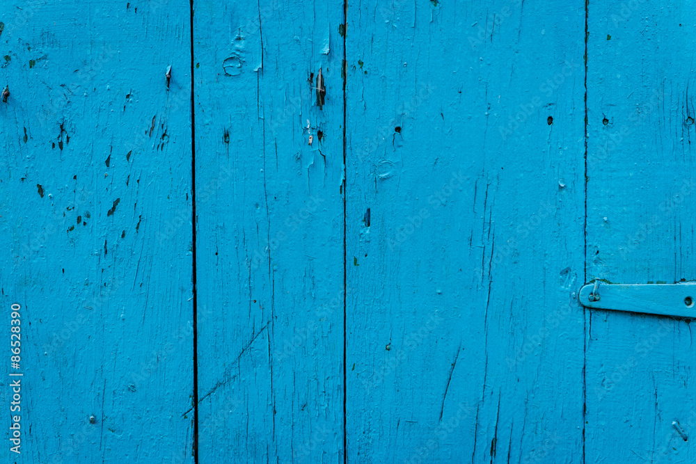 Wooden texture of blue color with scratches and cracks, which can be used as a background