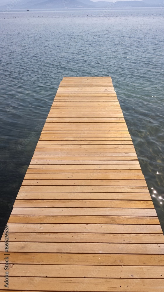 A wooden bridge over the sea and the mountains A wooden bridge over the sea and the mountains