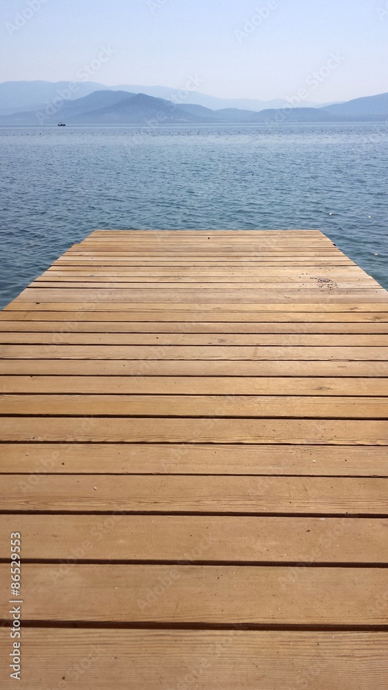 A wooden bridge over the sea and the mountains A wooden bridge over the sea and the mountains