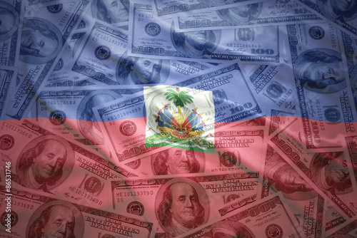 Canvas Print colorful waving haitian flag on a american dollar money background