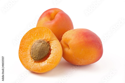 Two and half apricot with a stone on a white background