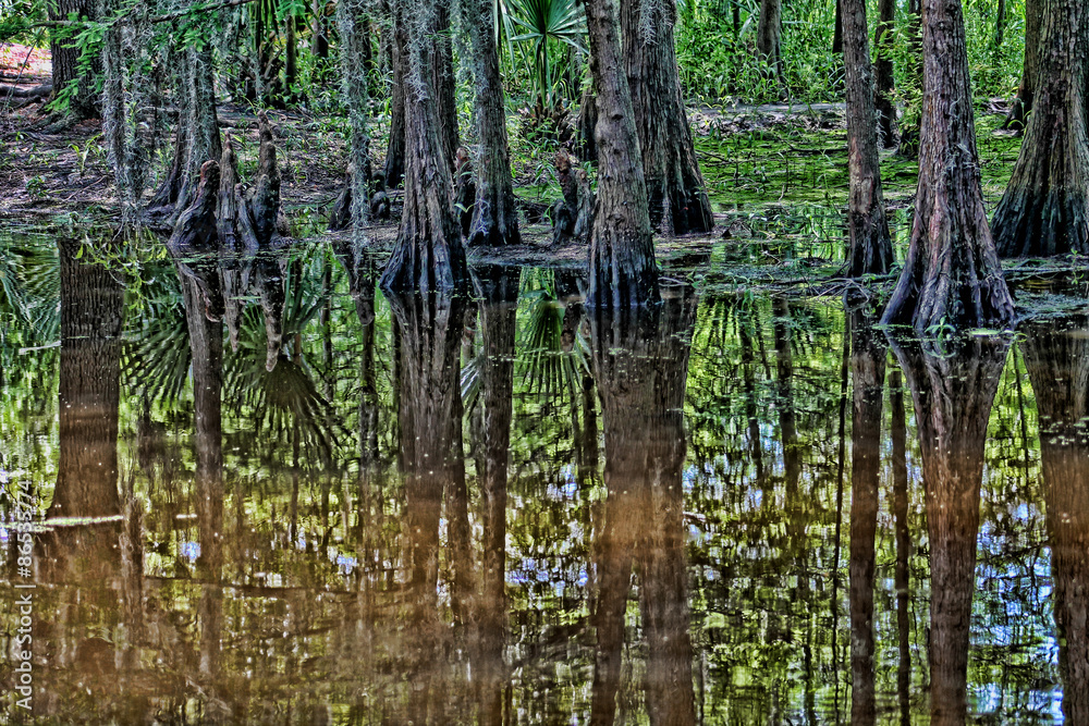 Fototapeta premium Breeze blows a curtain through a window near a simple table and chair