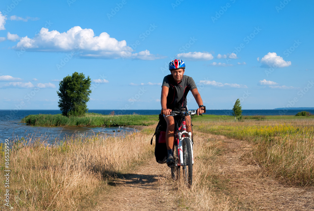 Mountain biker beside a beautiful river