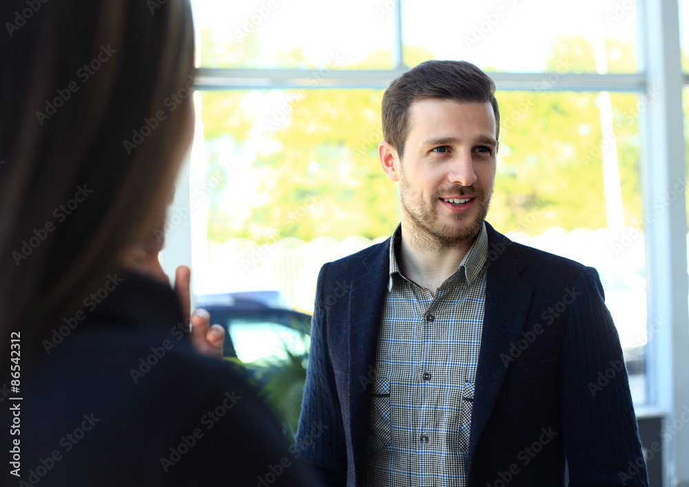 Happy smart business man with team mates discussing Happy smart business man with team mates discussing