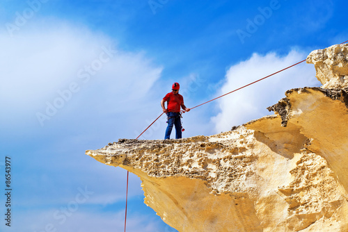 Rock climber rappelling