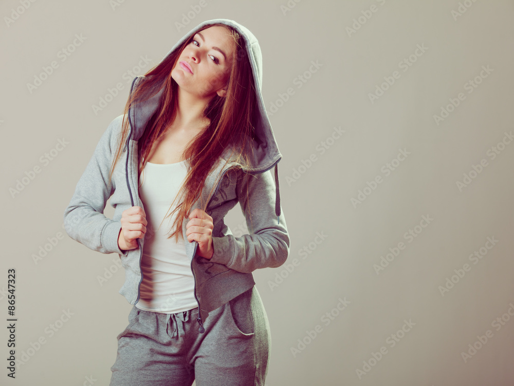 Pensive teenage girl in hooded sweatshirt. Fashion