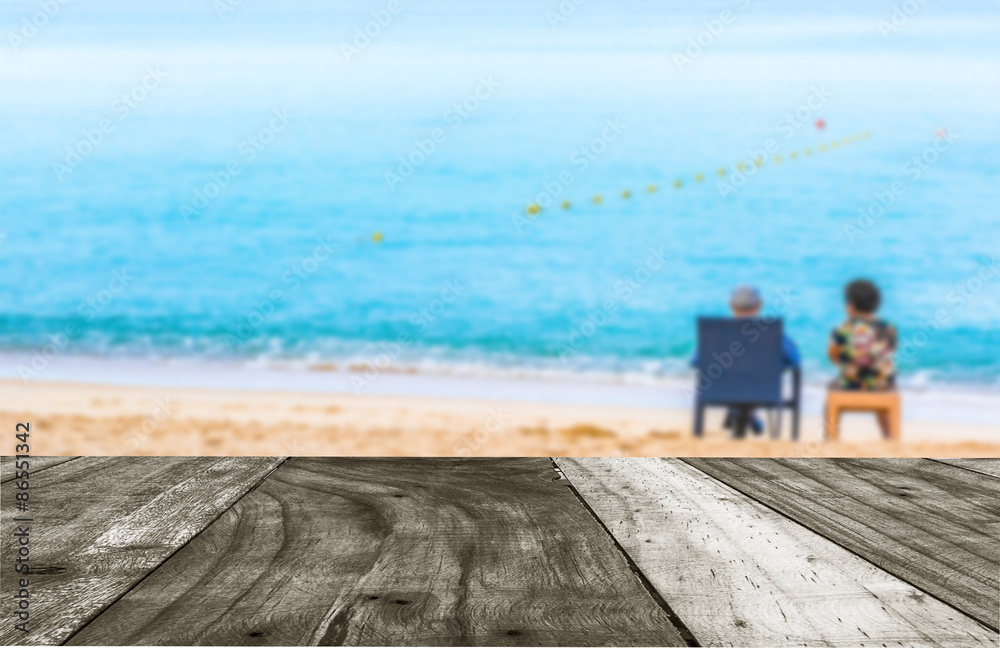  couple sitting on the beach looking on the horizon