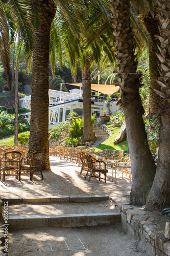 Very nice and modern restaurant surrounded with palms in Lloret de Mar in Spain
