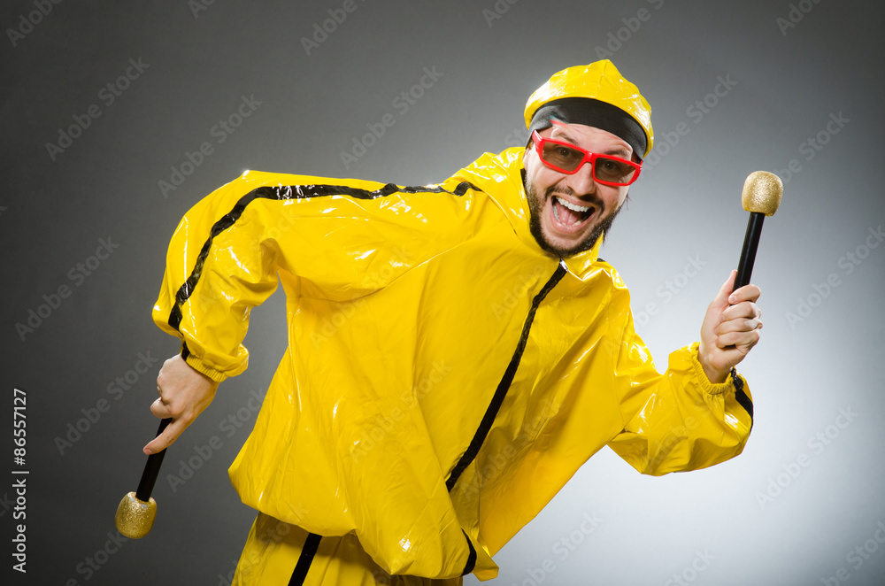 Man wearing yellow suit with mic Man wearing yellow suit with mic
