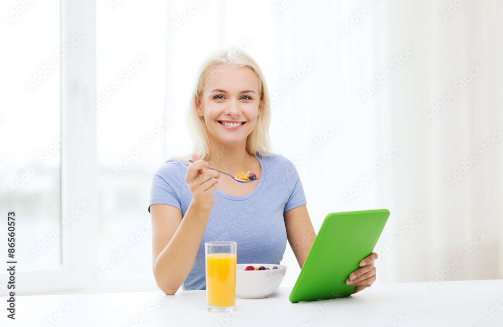 smiling woman with tablet pc eating breakfast smiling woman with tablet pc eating breakfast
