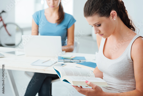 Teen girls studying at home
