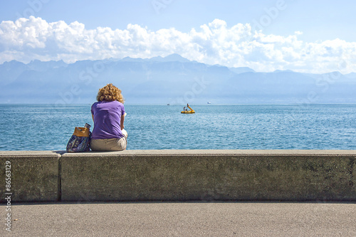 A woman in Lausanne quay of Geneva Lake in summer