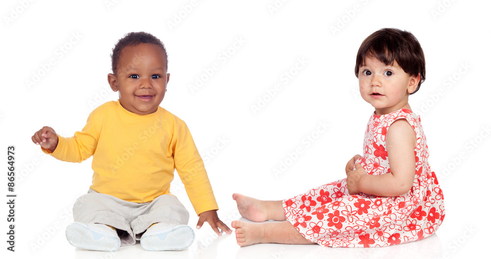 Couple of babies sitting on the floor Couple of babies sitting on the floor