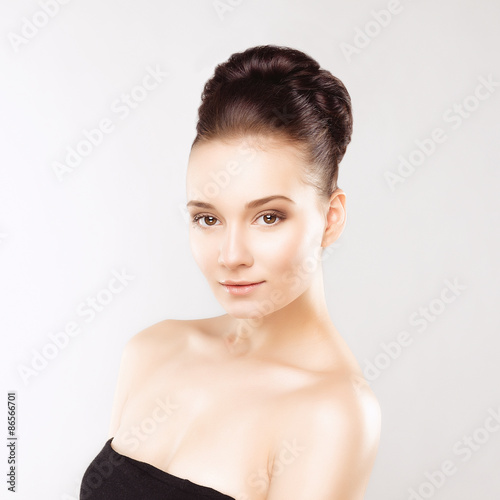 Portrait of Beautiful Young Woman with Clean Fresh Skin and Nude MakeUp. Isolated on White Background. Close up