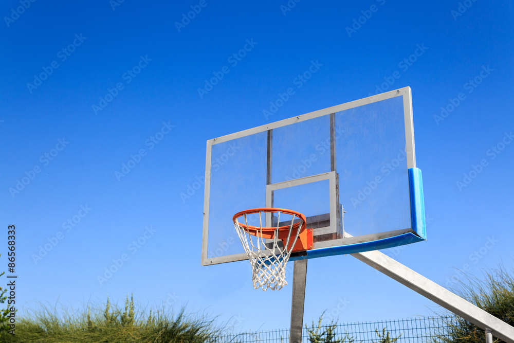 Basketball hoop on blue sky background