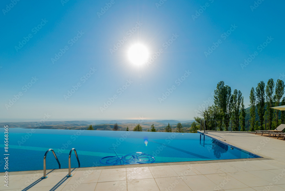 Fototapeta premium Infinity pool on the bright summer day