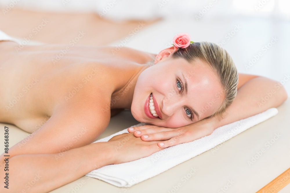 Peaceful blonde lying on towel smiling at camera Peaceful blonde lying on towel smiling at camera