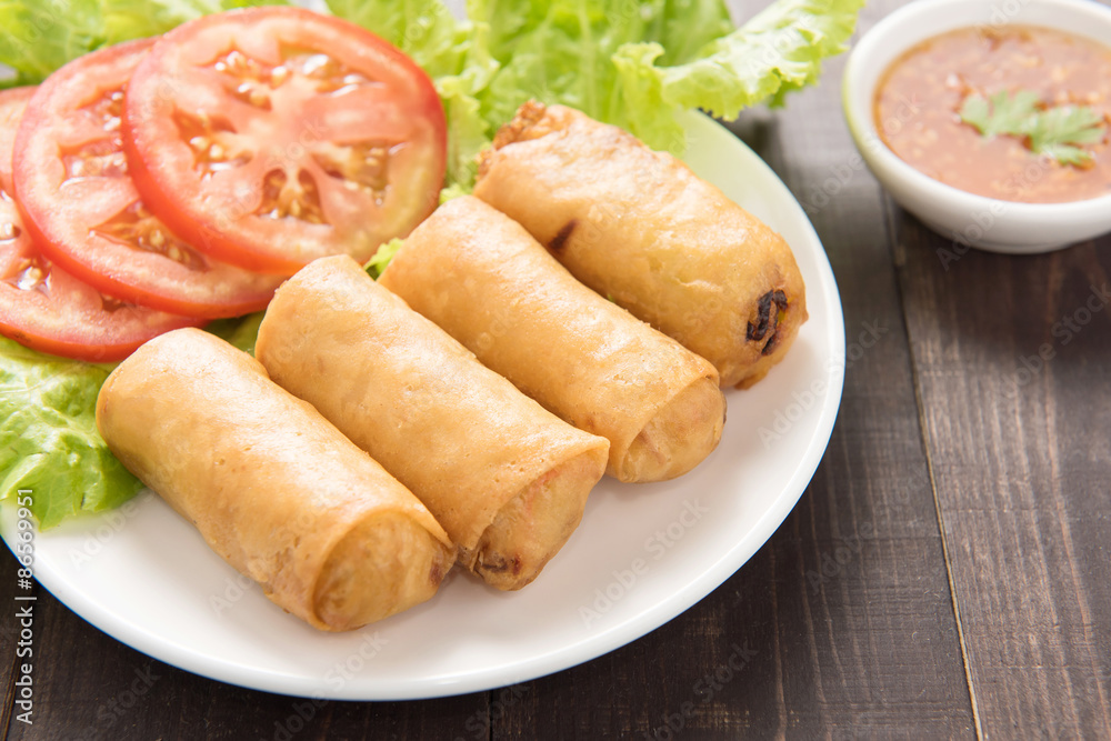 Fried Chinese traditional spring rolls on wooden background. Fried Chinese traditional spring rolls on wooden background.