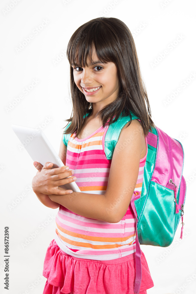 Cute and happy school girl holding a tablet