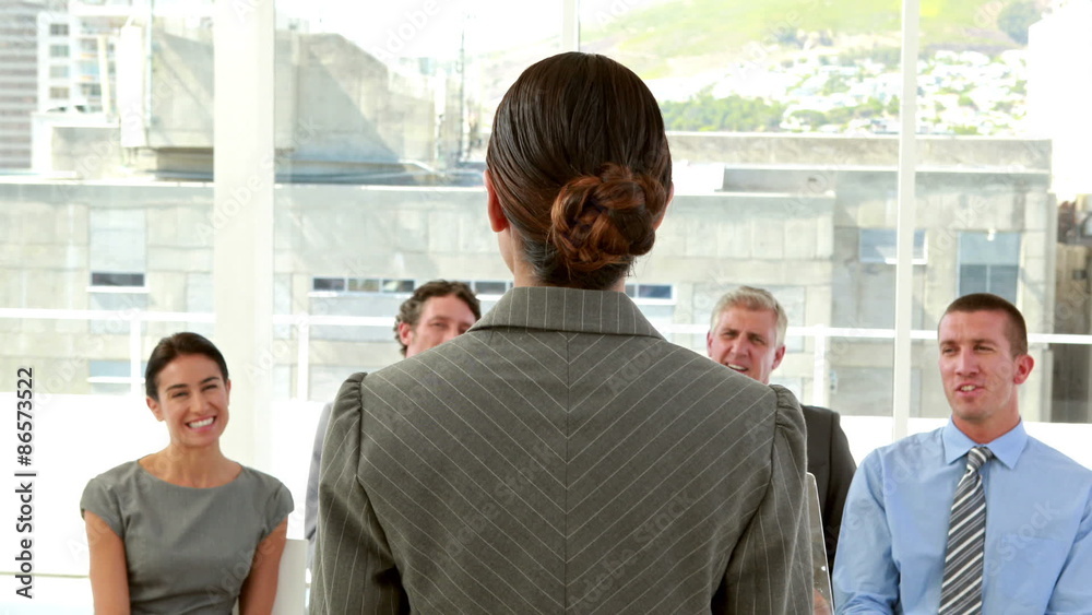 Happy business people looking at camera during presentation Happy business people looking at camera during presentation
