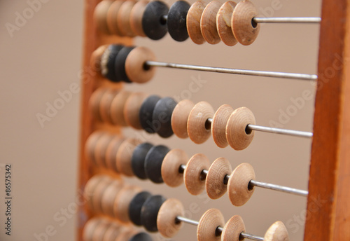 Old wooden abacus on gray background
