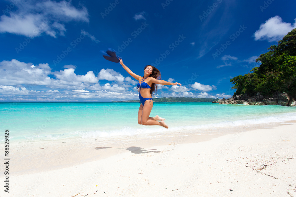 Beautiful woman jumping on beach