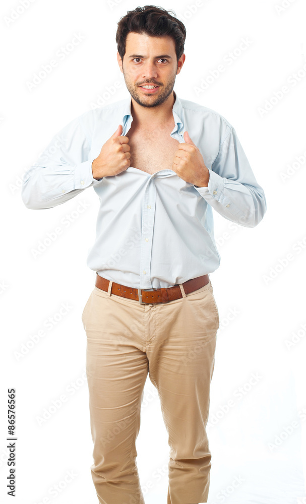 young man acting like a super hero and tearing his shirt off on a white background young man acting like a super hero and tearing his shirt off on a white background