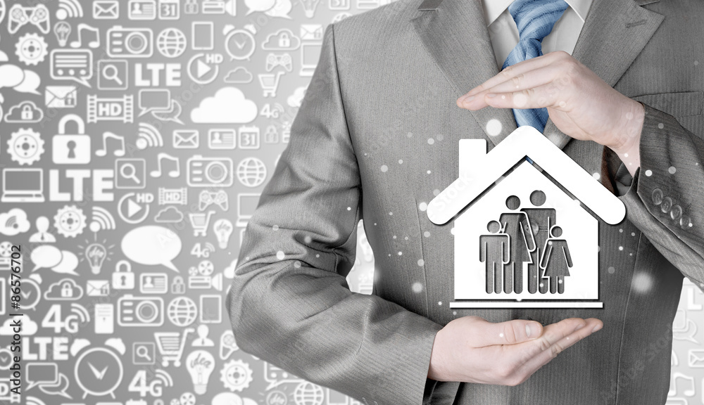 businessman protecting family in home with hands businessman protecting family in home with hands