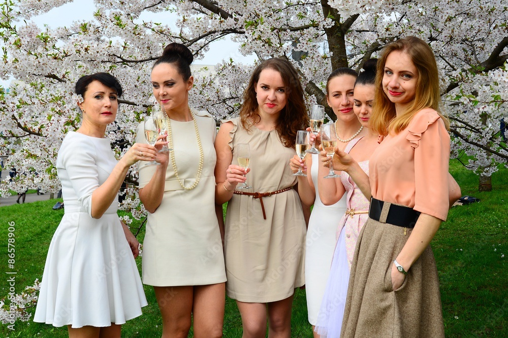Girls with champagne celebrating in sakura's garden. Girls with champagne celebrating in sakura's garden.