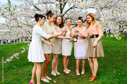 Girls with champagne celebrating in sakura's garden.