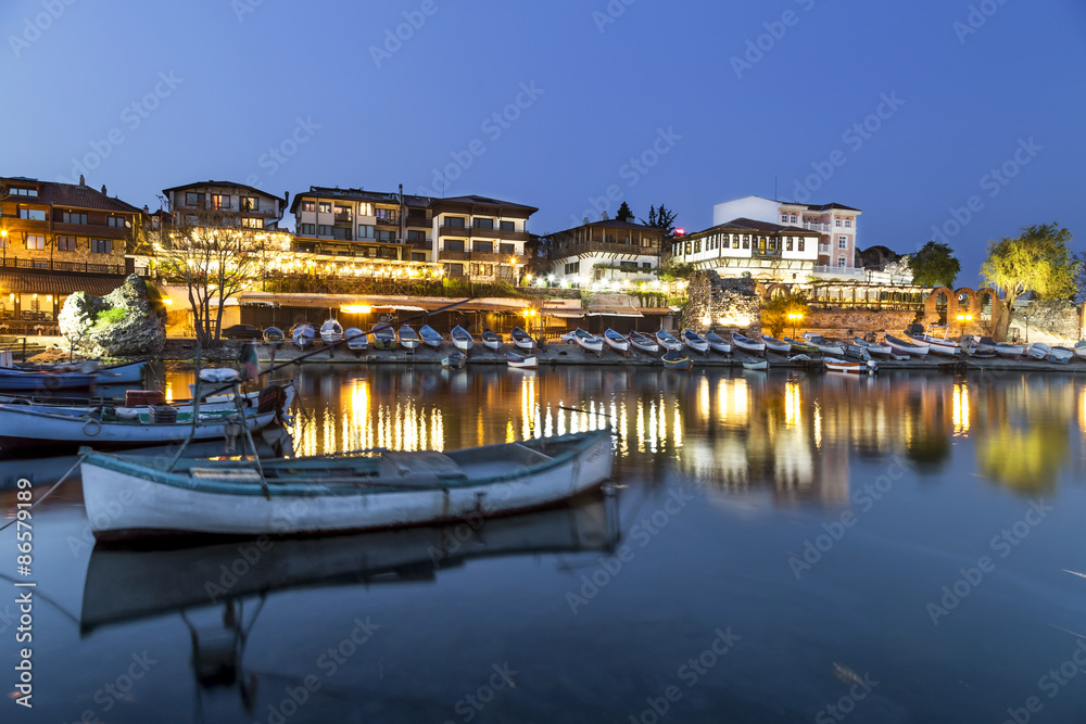 Fishing boats in costal city at night