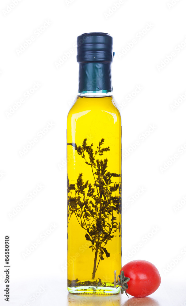 Olive oil in glass bottle and cherry tomato Olive oil in glass bottle and cherry tomato